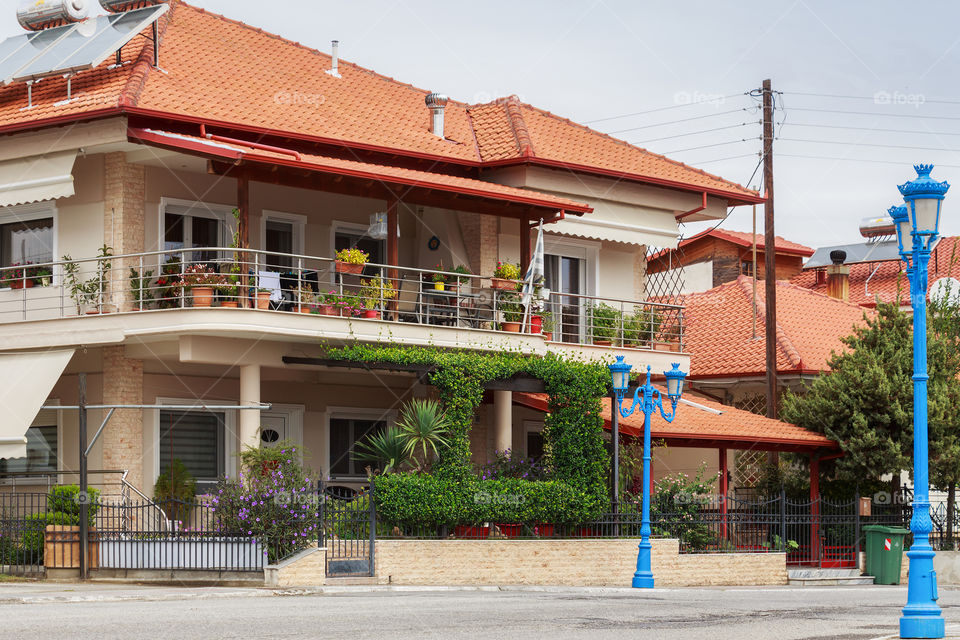 Beautiful house in Greece with terrace decorated with lot of flowers and palm
