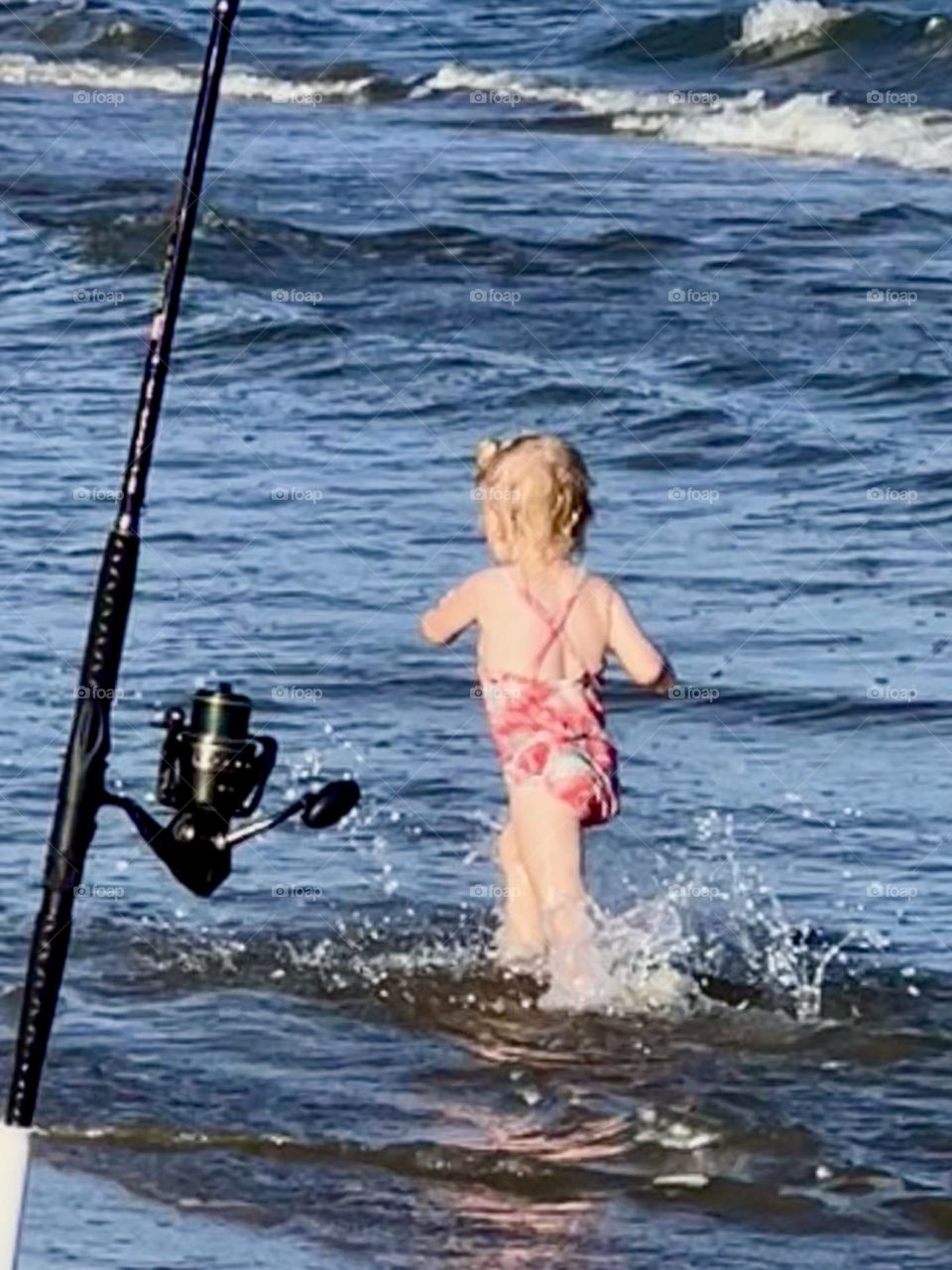 Editors choice. Cute little girl running along the beach and my fishing pole! San Luis Pass TX