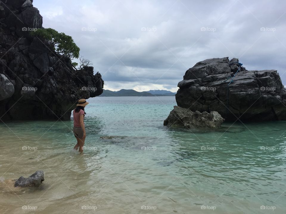 One woman walking into the water