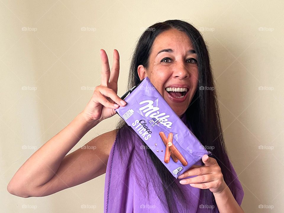 Energetic, Light-Hearted Portrait of Beautiful Smiling Woman with Milka Chocolate Sticks