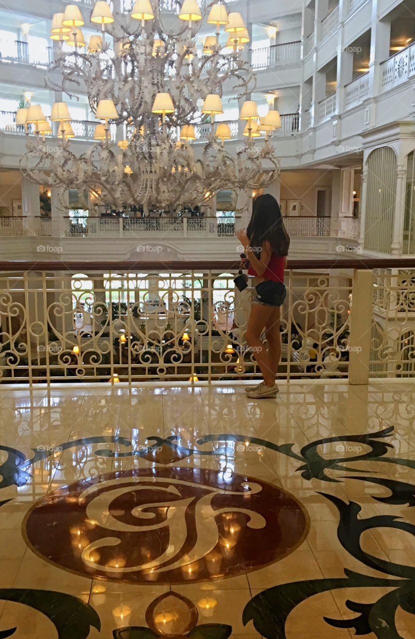 Rear view of a woman standing near railing