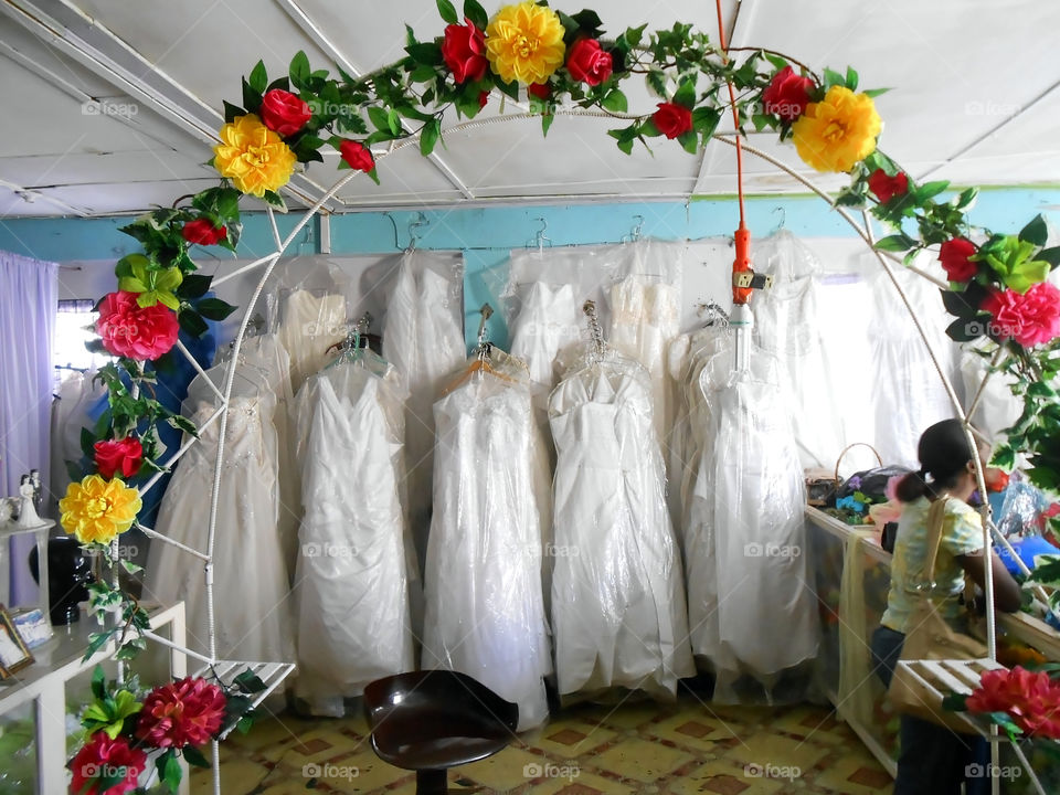 Arch and gowns on display in a shop