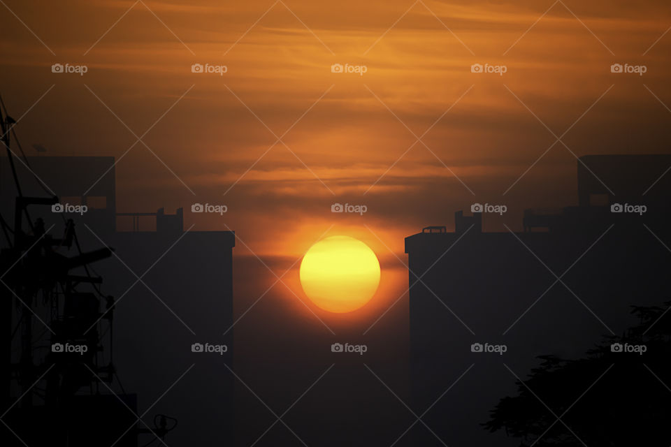 The early morning sunlight shining on large buildings.