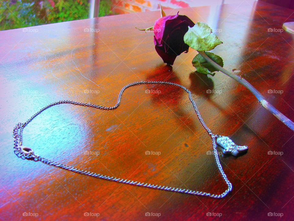 Heart shaped necklace with dead rose