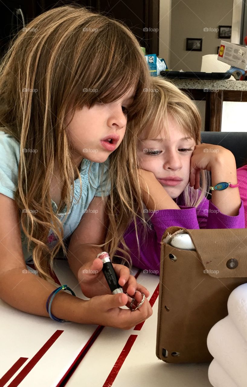 Two sister looking at tablet