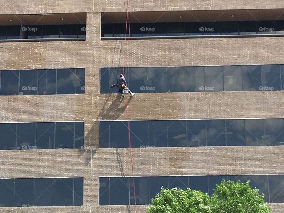 A great photo on a very hot windy day in the Texas panhandle, cleaning windows while swinging away 