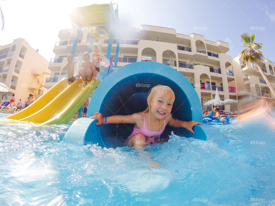 Four year old girl playing in the water on her holiday on Majorca.