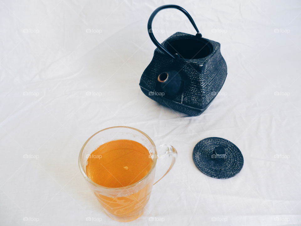 tea pot and a cup of green tea on a white background