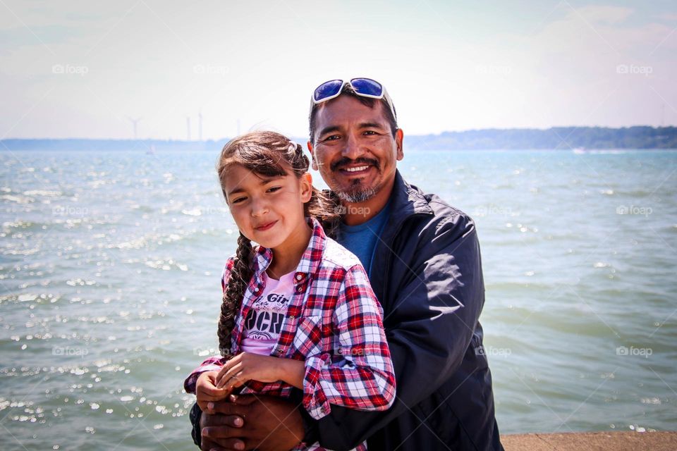 Father and daughter together by the lake