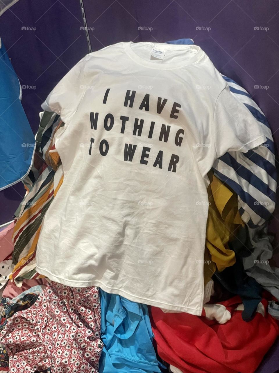 I have nothing to wear t-shirt on top of a pile of clothes !