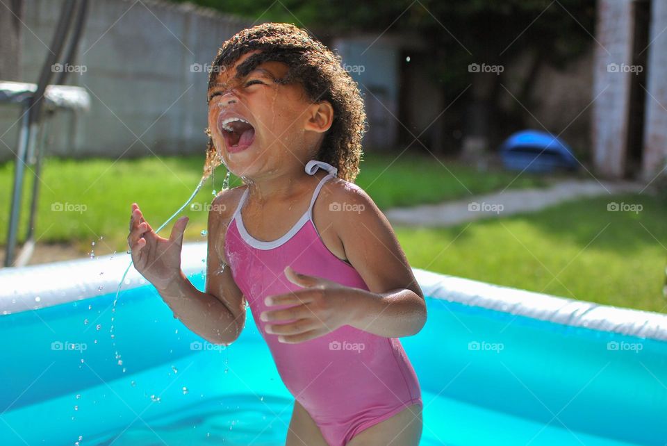 Little girl having fun in swimming pool