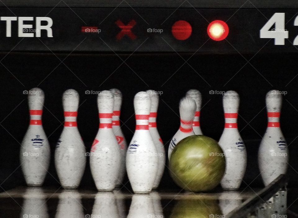 American Bowling. Bowling Ball About To Knock Down Pins
