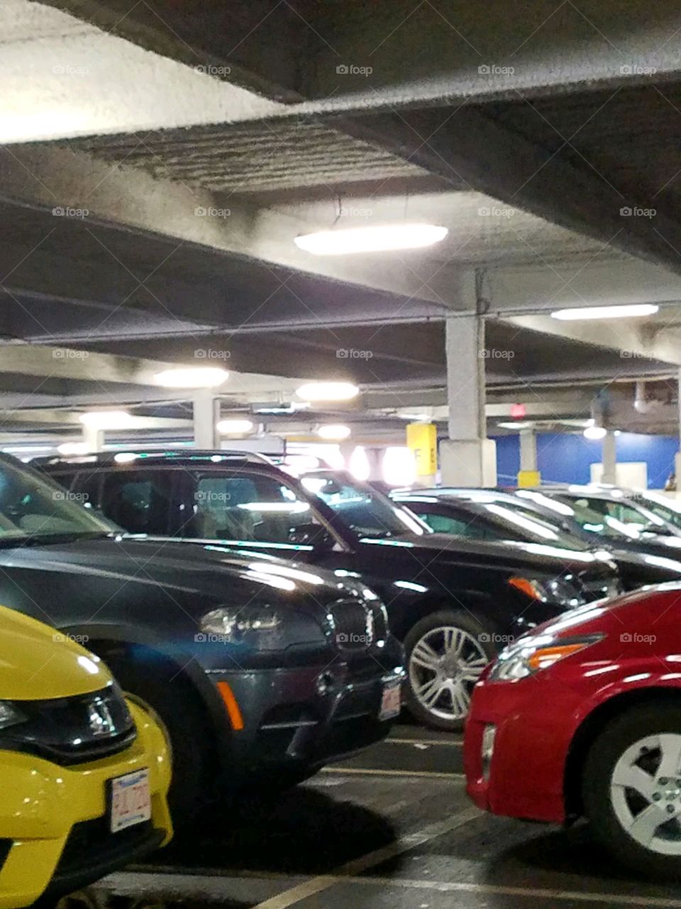 Parking level completely full with cars. Lighted ceiling since it's dark out. Lot is easy to get lost in