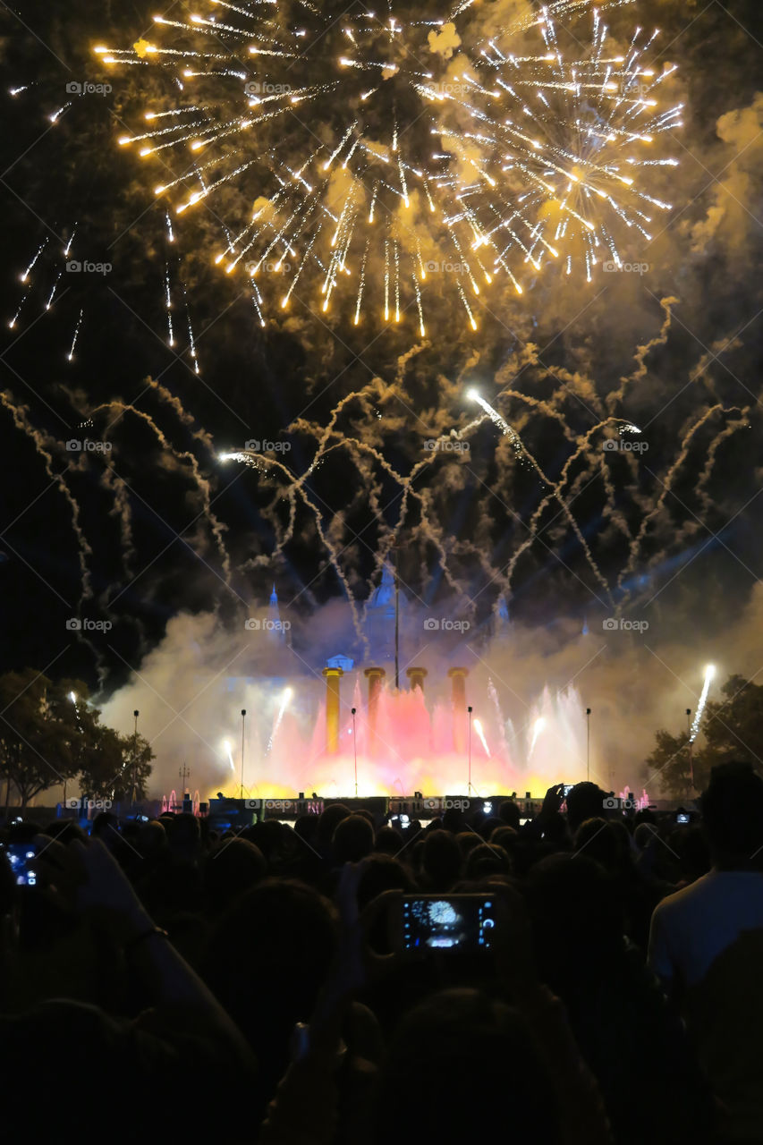 Crowd at the  pyrotechnics finale fireworks show of La Merce 2016 celebrations at Plaza de Espana in Barcelona, Spain.