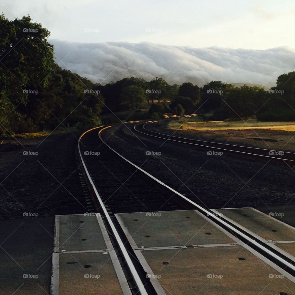 Fog coming. Railroad tracks and fog coming over the hills
