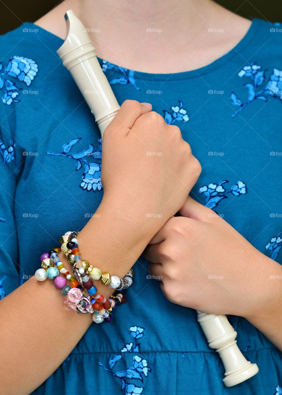 Young girl hugging her recorder