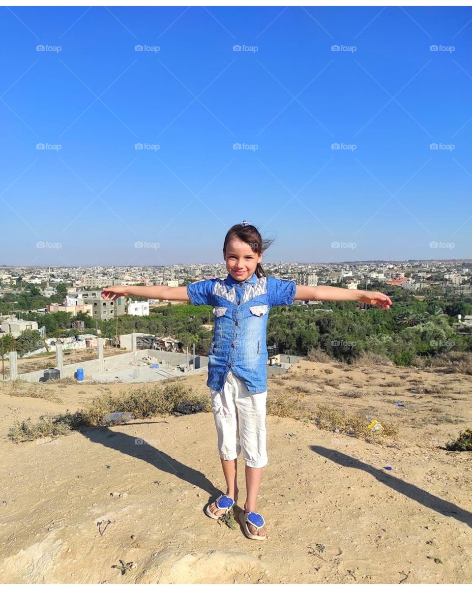 The little girl feels free and happy in the open air