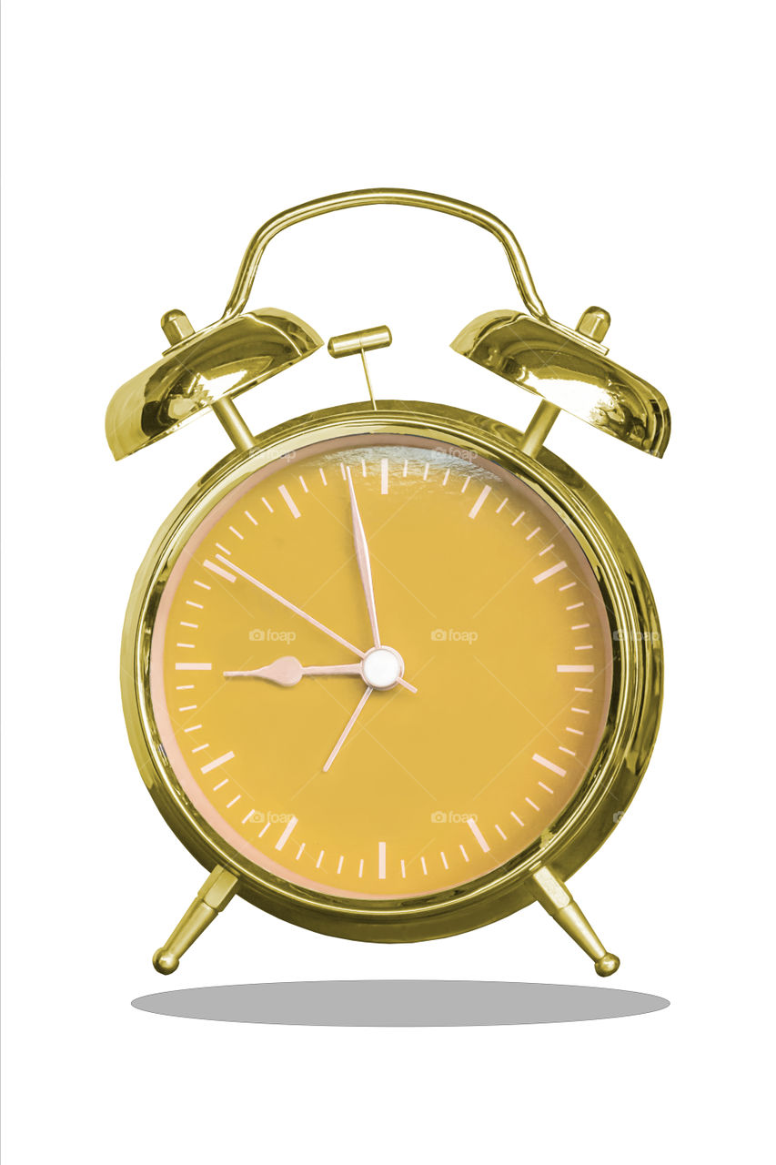 Isolated Alarm clock with a gold and Orange dial on a white background with clipping path.