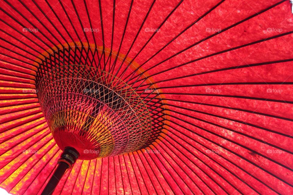 Under a red Japanese parasol