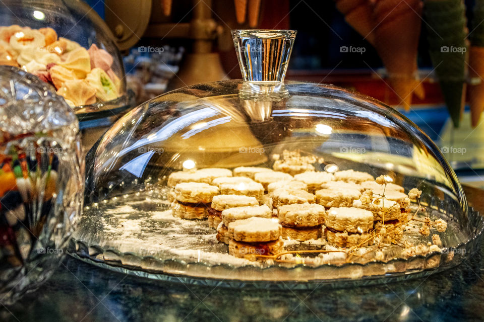 Pastry shop - "vanilla cakes under an oval glass lid on a plates"