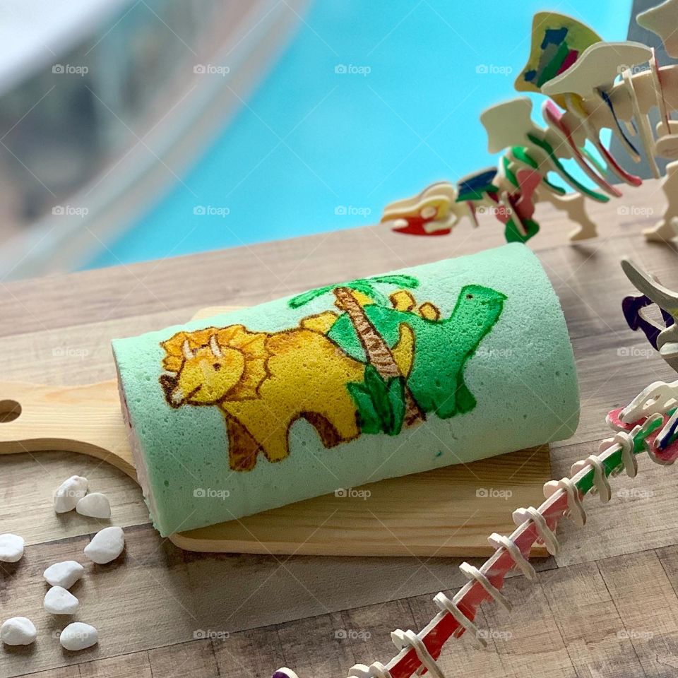 Triceratops and stegosaurus dino cake roll in strawberry flavour 