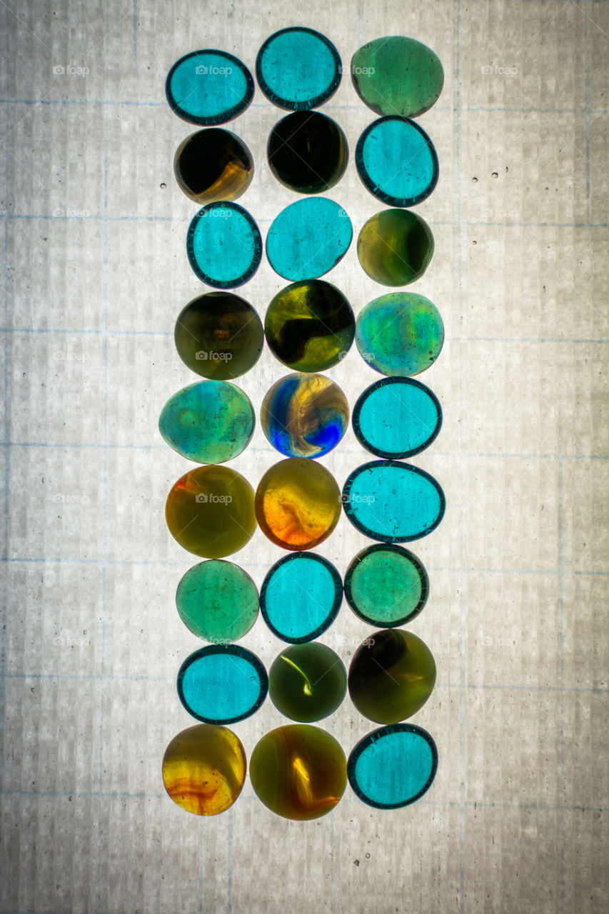 Colored glass beads on a light table. 