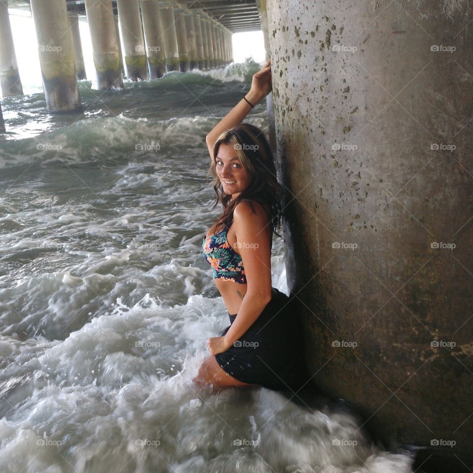 Woman posing under the pier