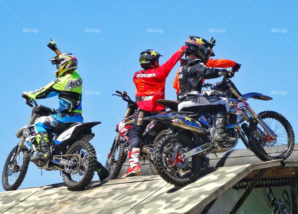 Motorcycle Stunt Team. High Performance Motorcycle Stunt Team Saluting Their Crowd
