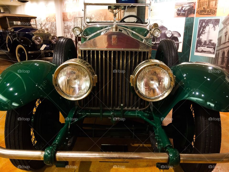 Antique shiny green car from front view
