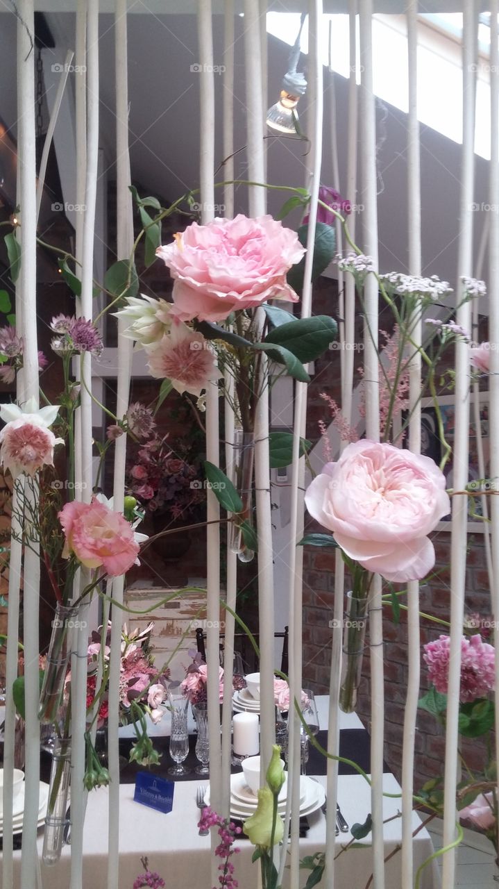 Delicate pink roses brighten the setting of a glamorous event
