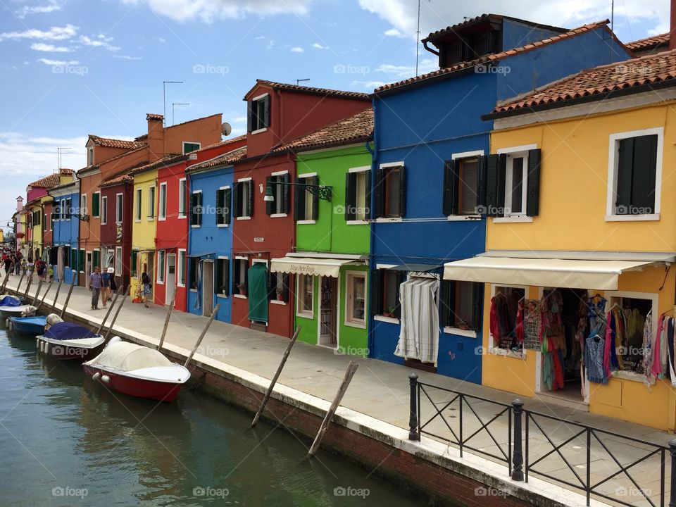 Canal in Burano. Multi coloured houses on the Venetian island of Burano