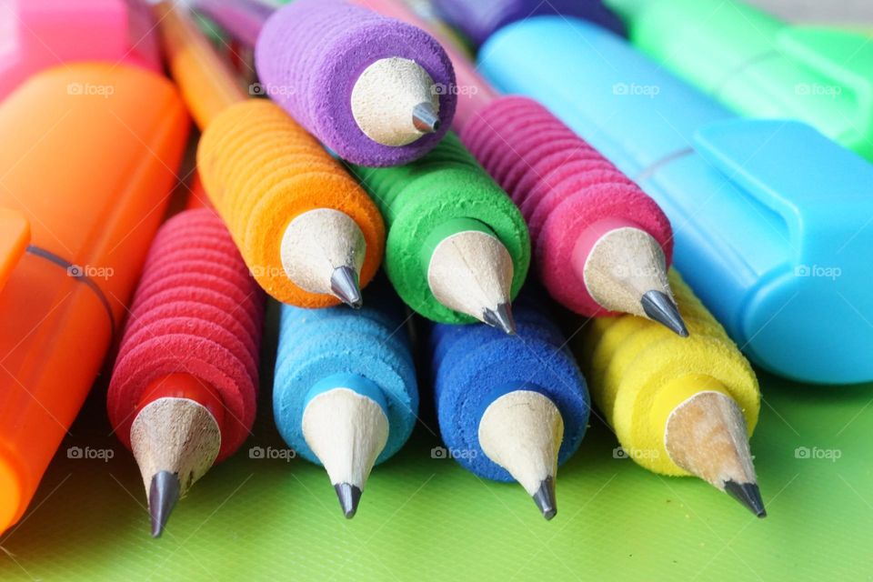 A stack of colourful pencil grippers 