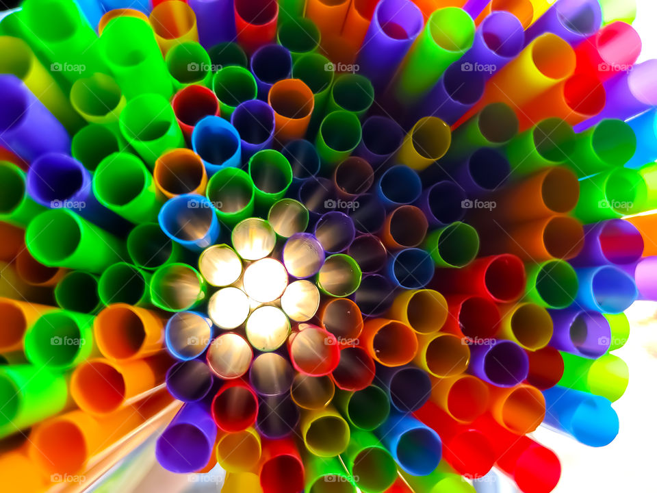 Light shining through rainbow colored straws.