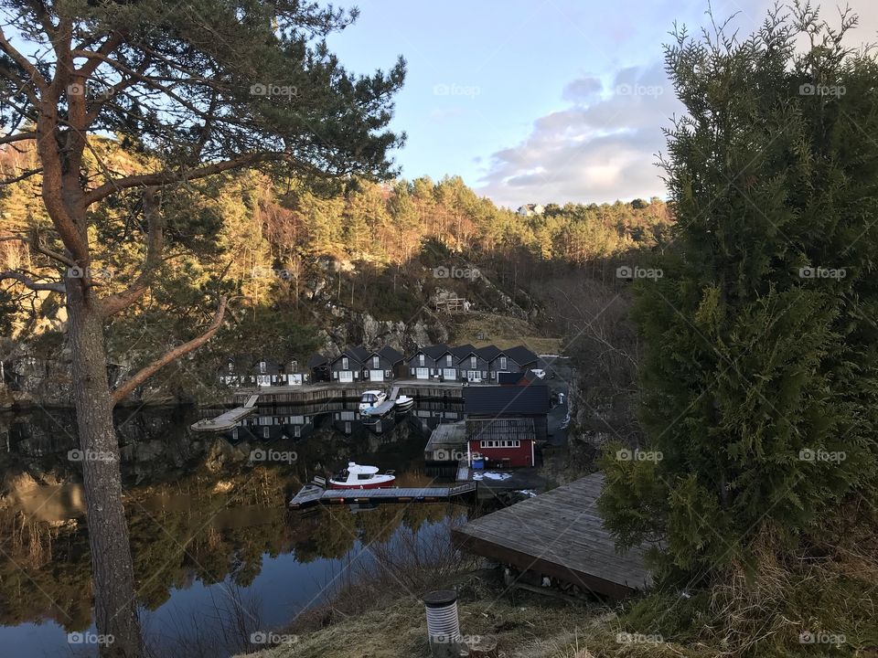 Boathouses in Norway with bridges and boats.                                      