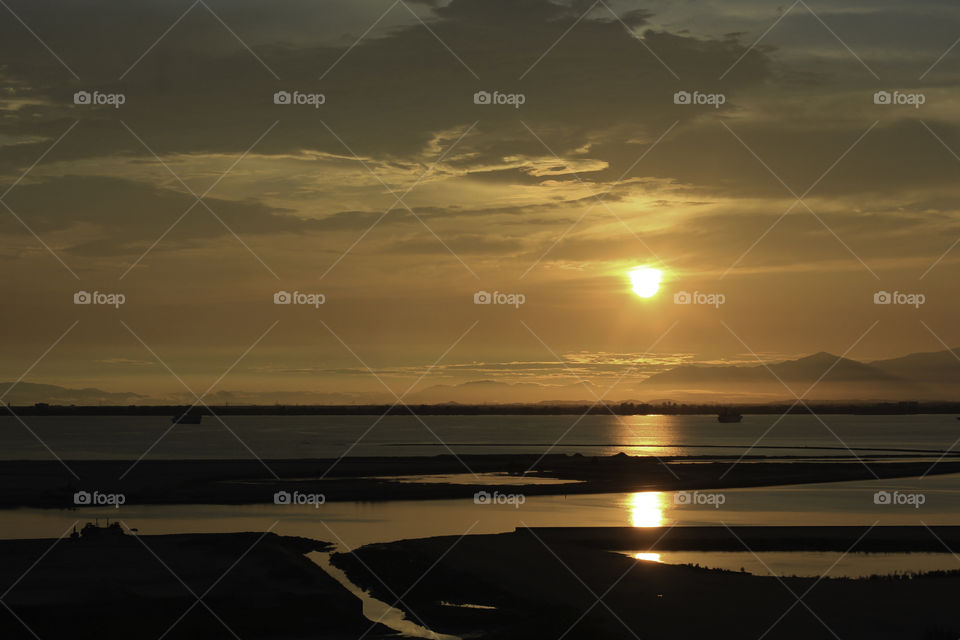 Morning Sun rises up over Penang island’s coast.