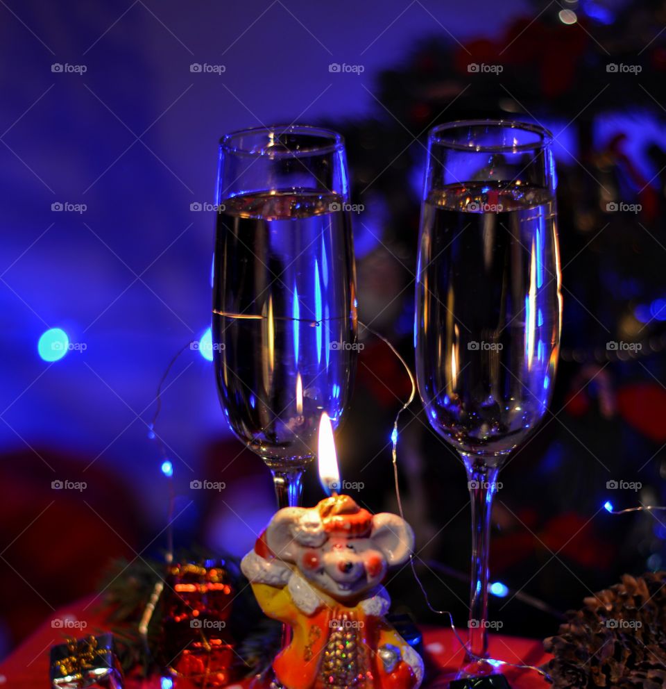 burning candle rat symbol New year and champagne glasses winter holiday