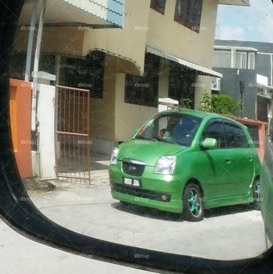 green car in the mirror