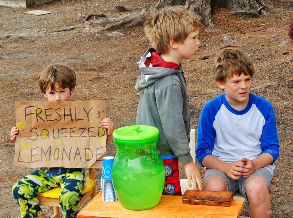 Group of children selling lemonade at park