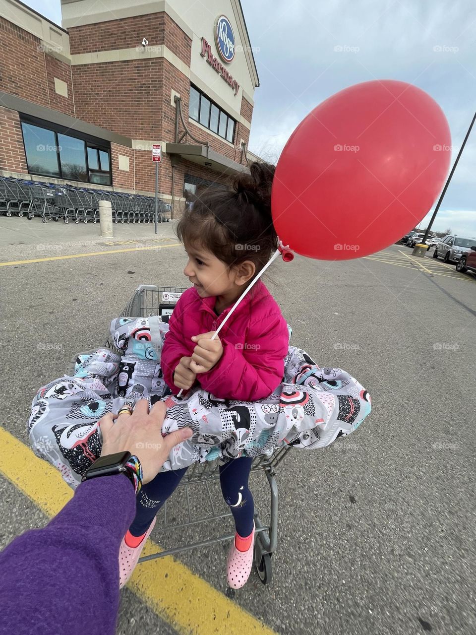 Mother pushes little girl in cart, going to the grocery store, shopping with toddlers, everyday tasks, daily activities, mundane tasks, toddlers in grocery stores