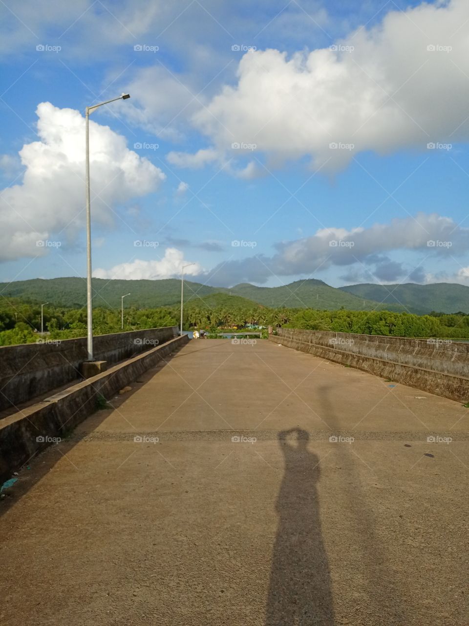 shadow of a man taking a beautiful Photo of nature