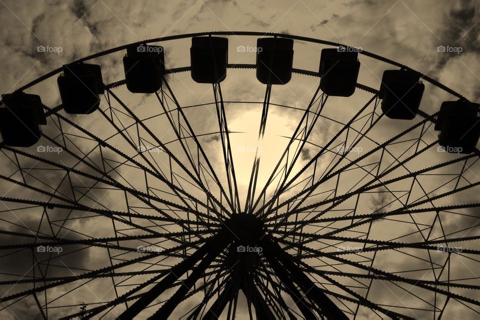 Sepia Ferris wheel, abandoned Ferris wheel, exploring abandoned amusement parks, Ferris wheels in the sky, looking up at a Ferris wheel