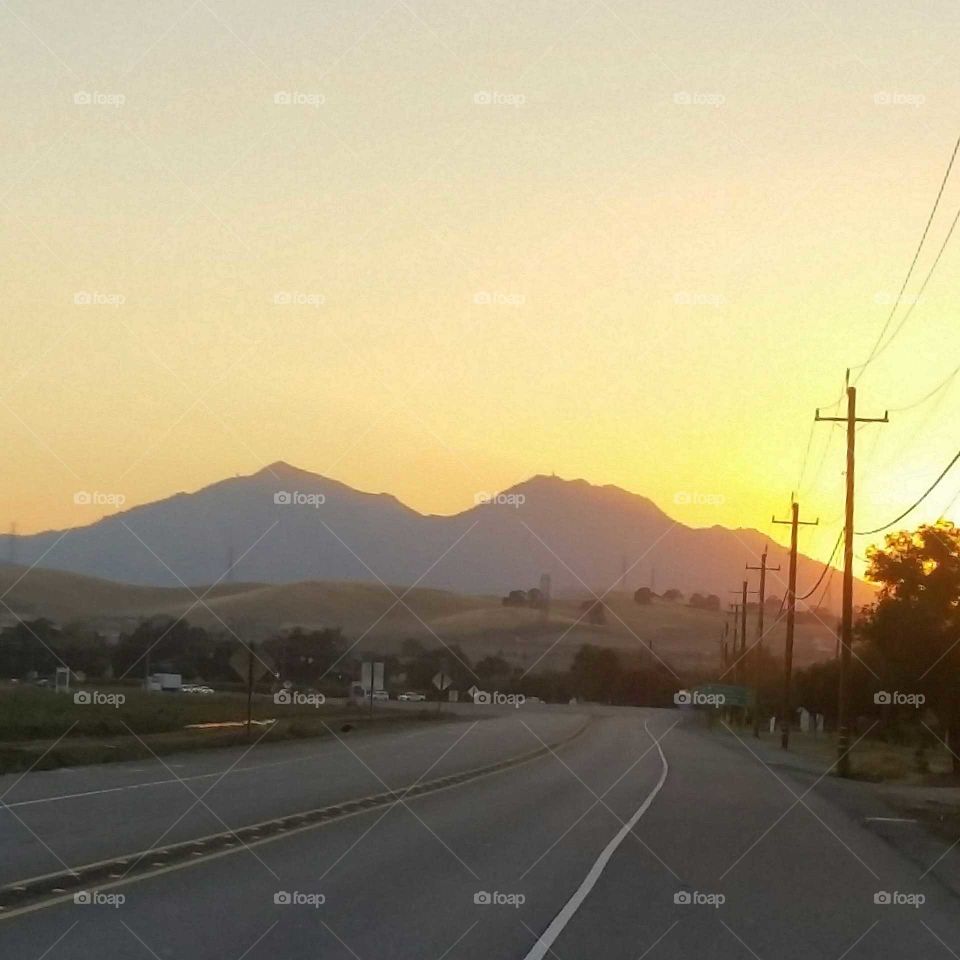 beautiful sunset behind a dark mountain.