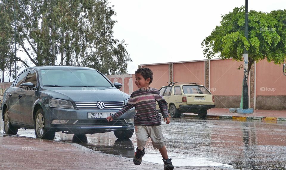 happy kid in front of a car