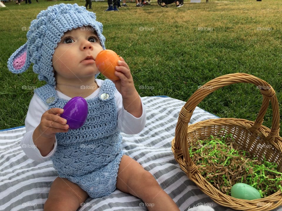 Baby’s first Easter with basket and eggs 