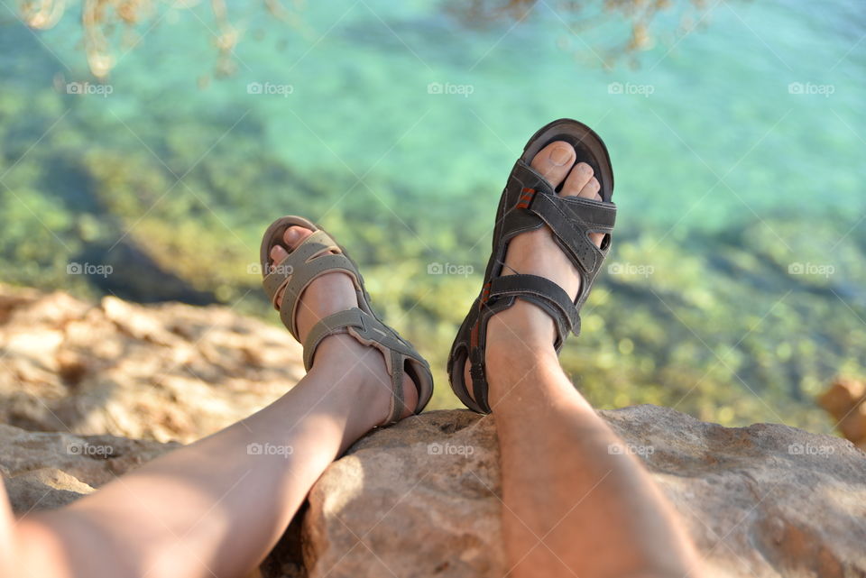 Close-up of person's leg wearing sandal