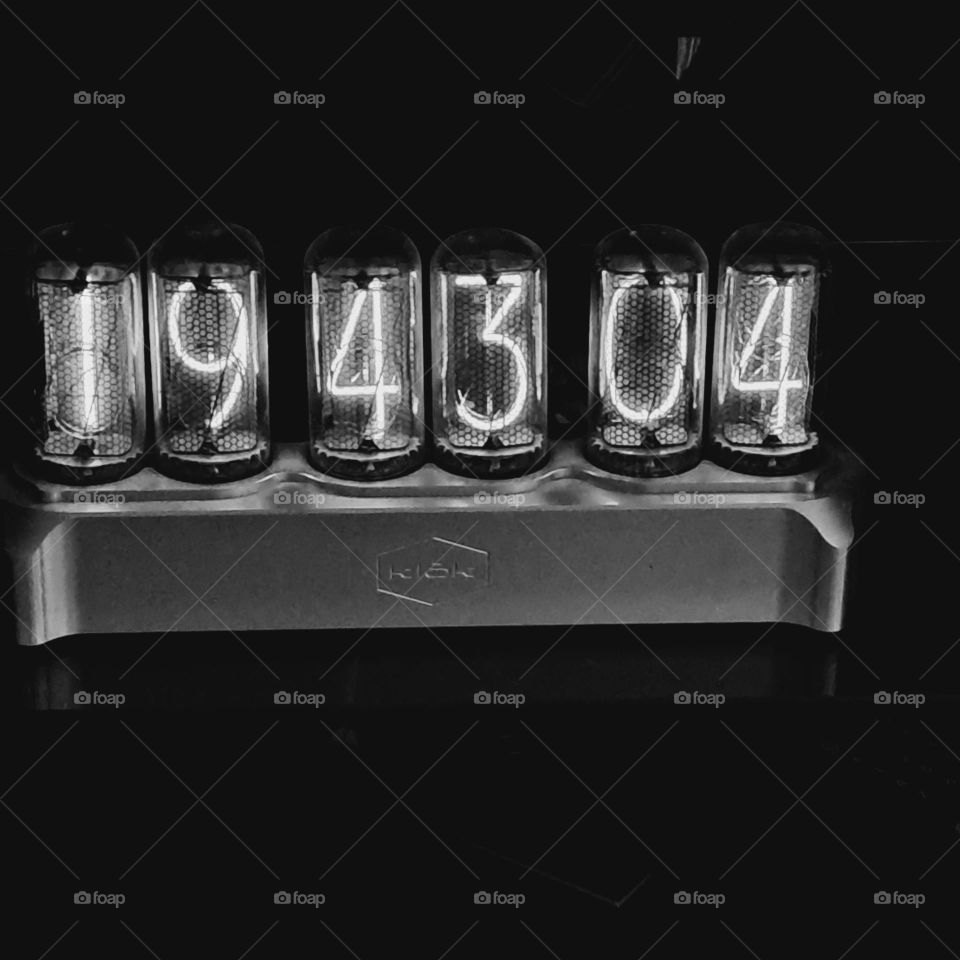 Black and white. Digital clock lit up, counting down the seconds and minutes of life.