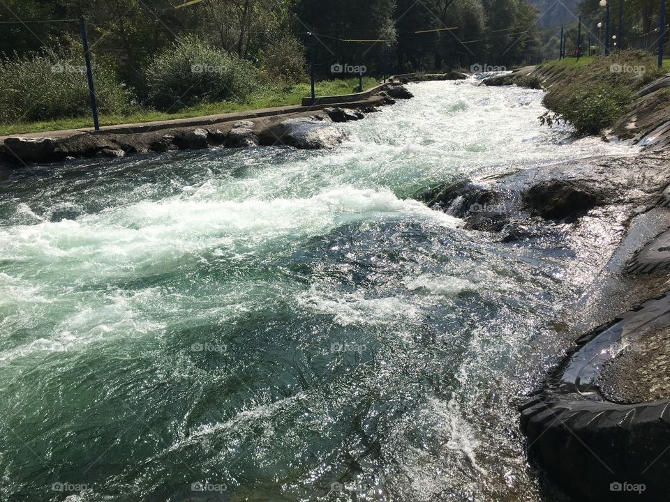 View of river flowing through rocks