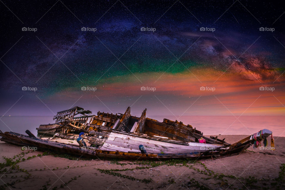 wreck on the beach and milky way