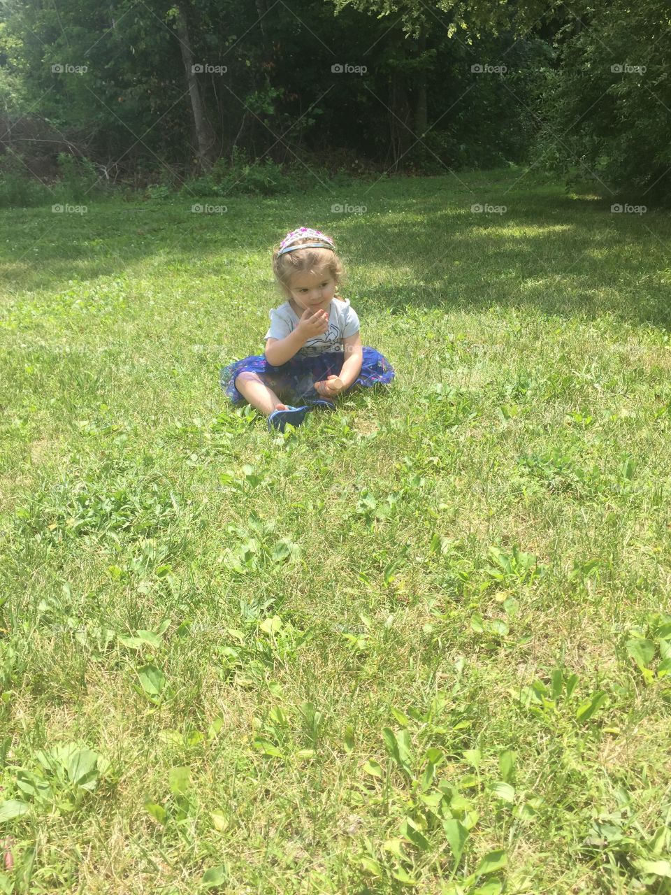 She’s just sitting in some grass