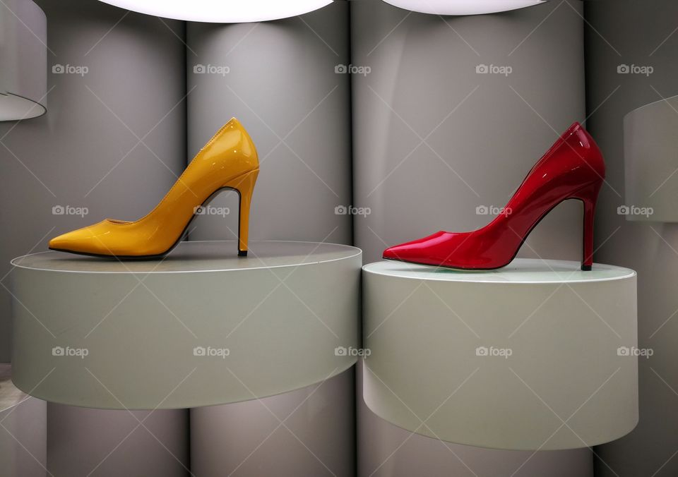 Bright yellow and red high heels on modern display